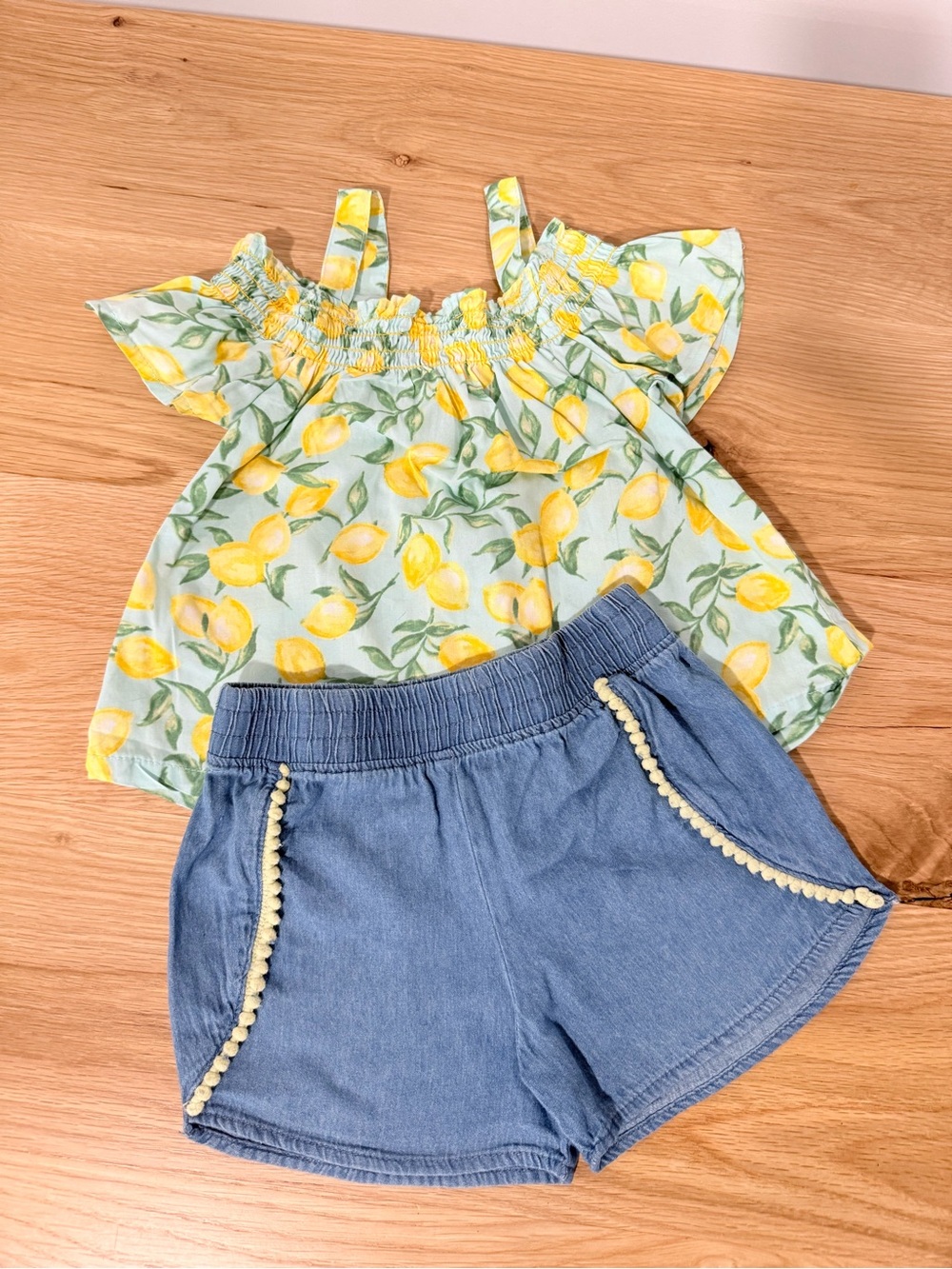 Penelope Mack Light Blue Denim Shorts with Pom Trim and Lemon Shoulder Peek-Top